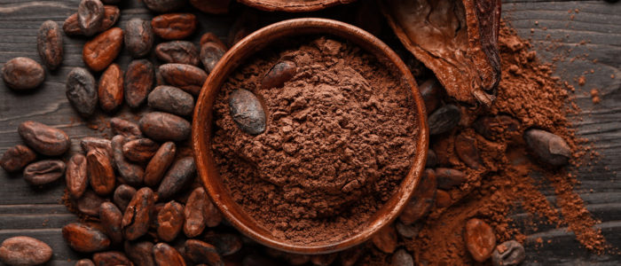 Bowl,With,Cocoa,Beans,On,Wooden,Background